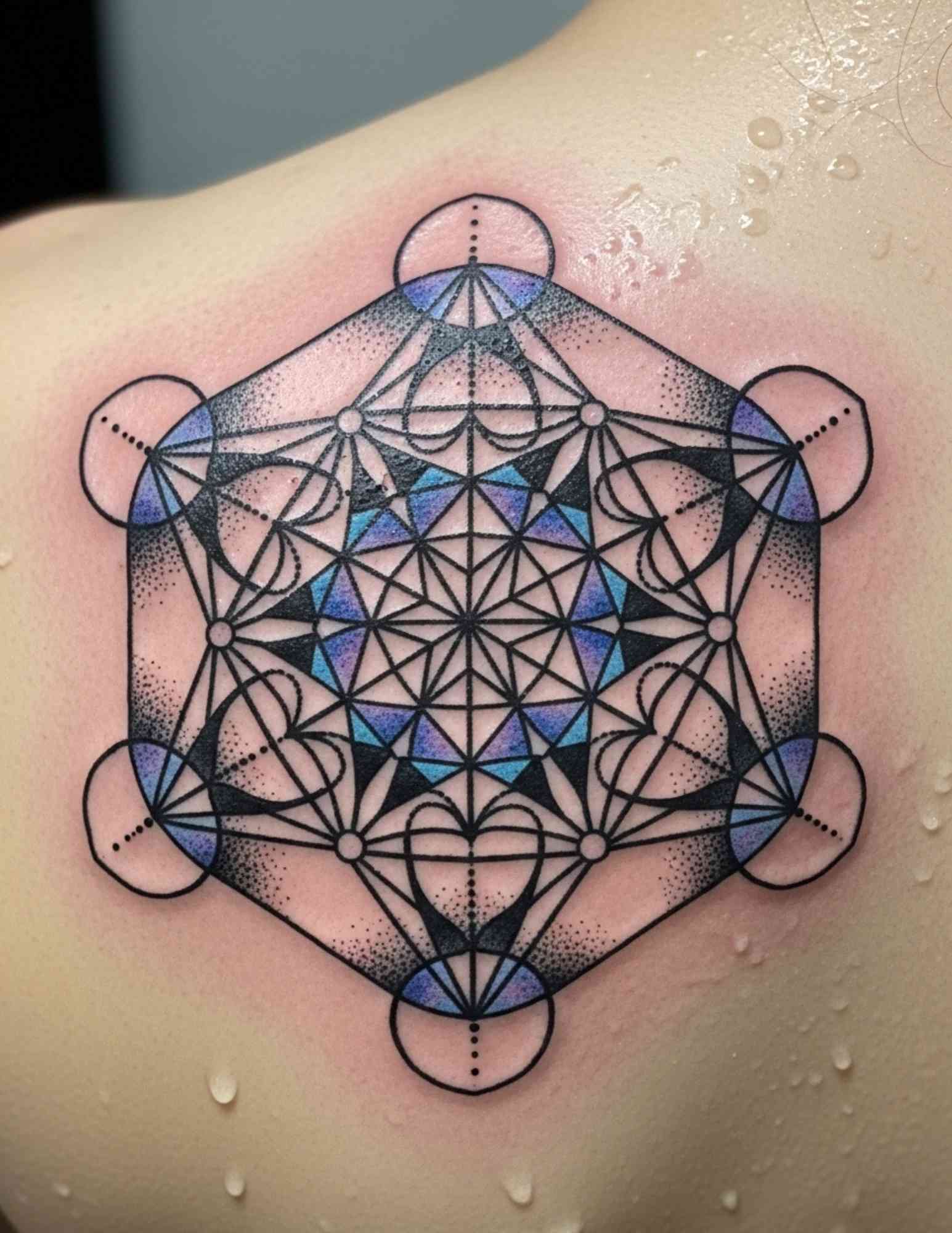 Metatron's Cube sacred geometry tattoo with precise straight linework on the chest
