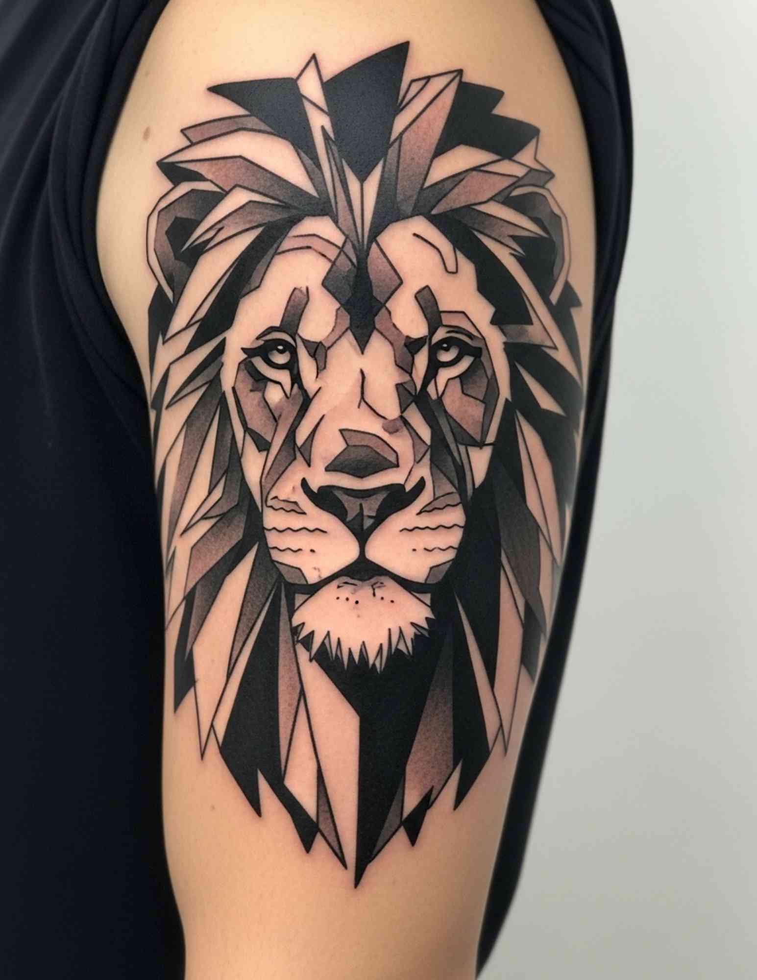 Blackwork geometric lion tattoo using solid black fills and negative space