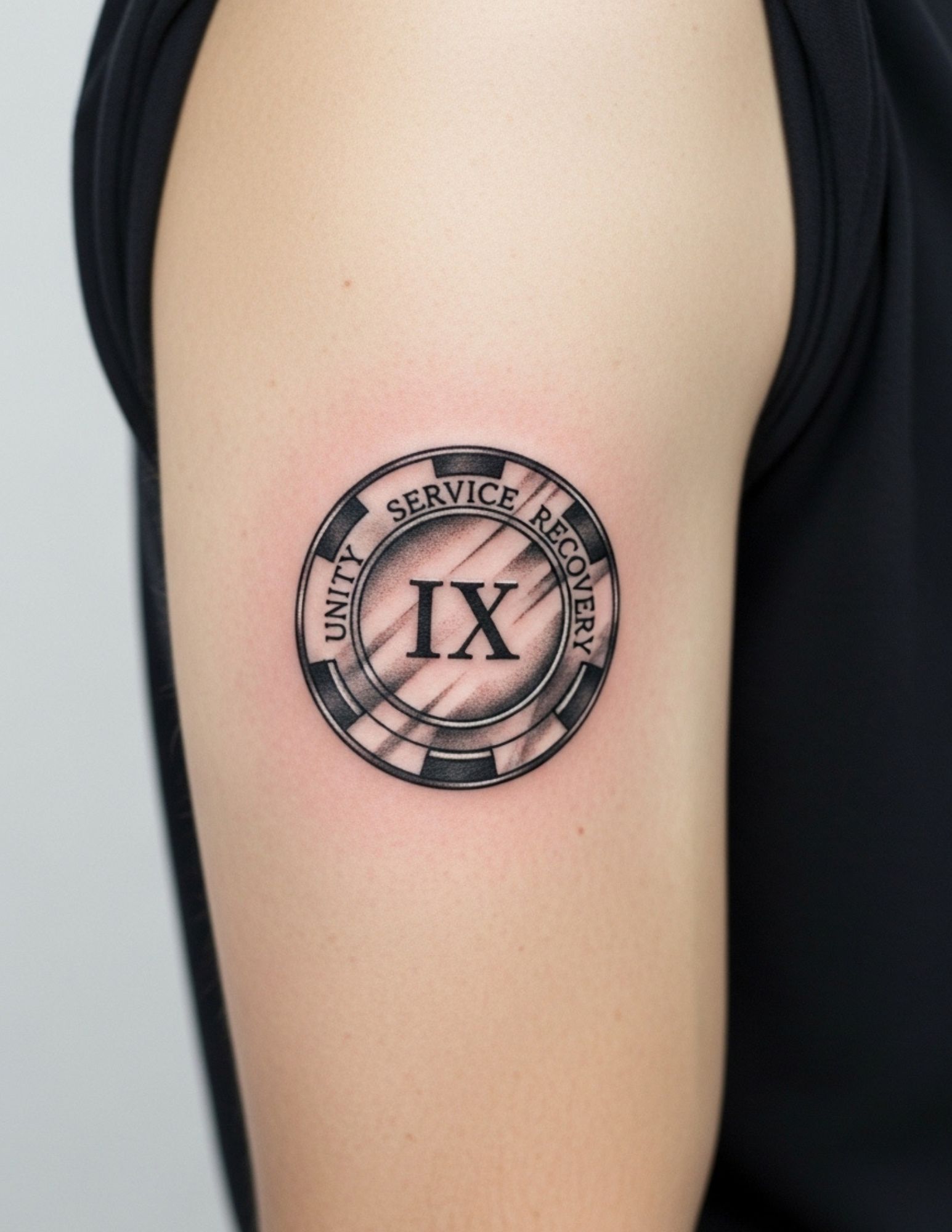 Sobriety chip tattoo rendered as a circular recovery token in black ink