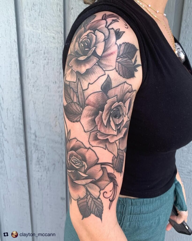 Black and grey rose sleeve tattoo showing full tonal range from deep shadow to pale highlight