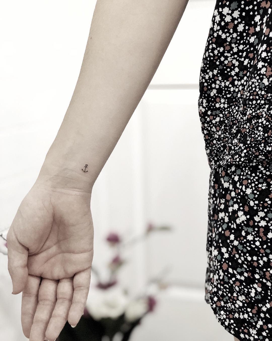 Tiny anchor wrist tattoo in minimal traditional style