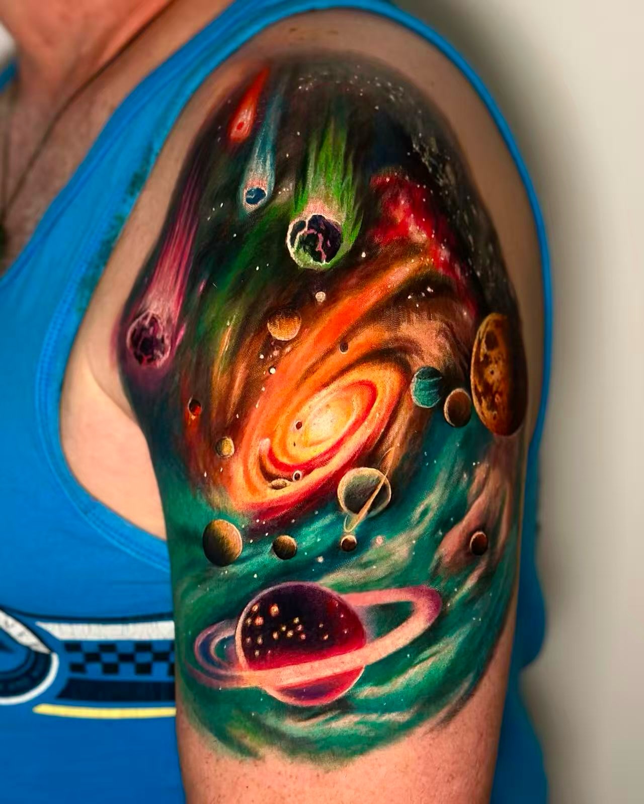 Colour realism space tattoo of a nebula in deep purple, blue and pink tones