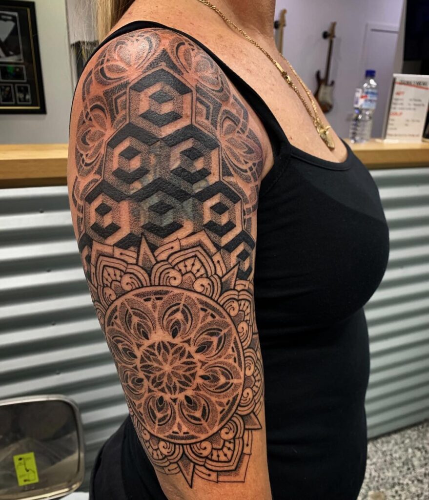 Mandala cover up tattoo centred over an existing design, the radiating geometry masking the old lines.