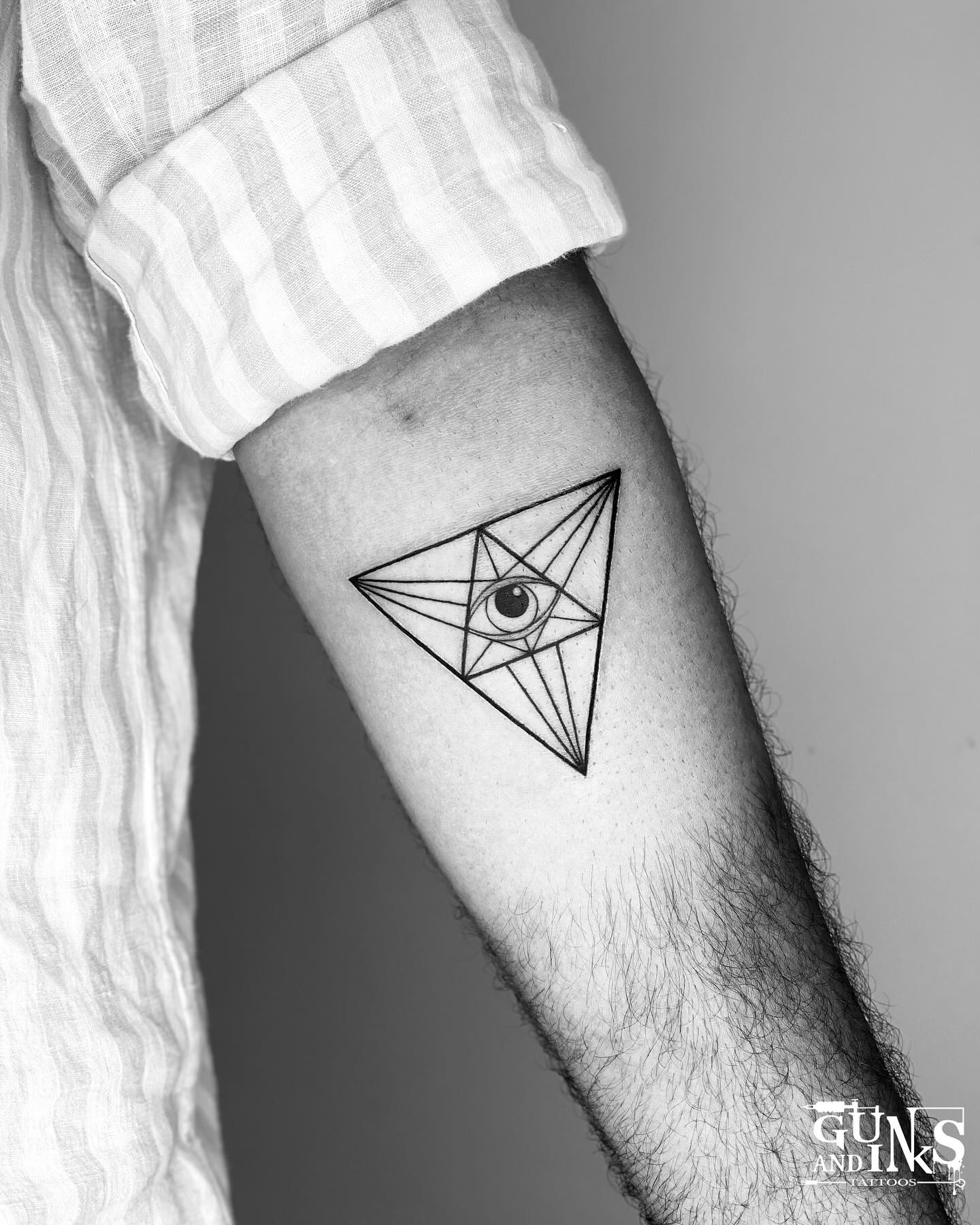 Triangle all-seeing eye geometric tattoo for men with radiating linework