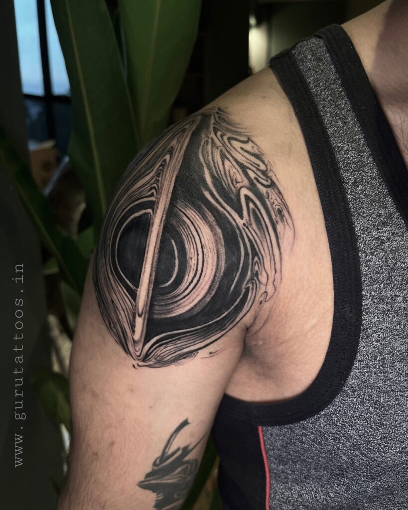 Black hole space tattoo showing the event horizon and glowing accretion disc