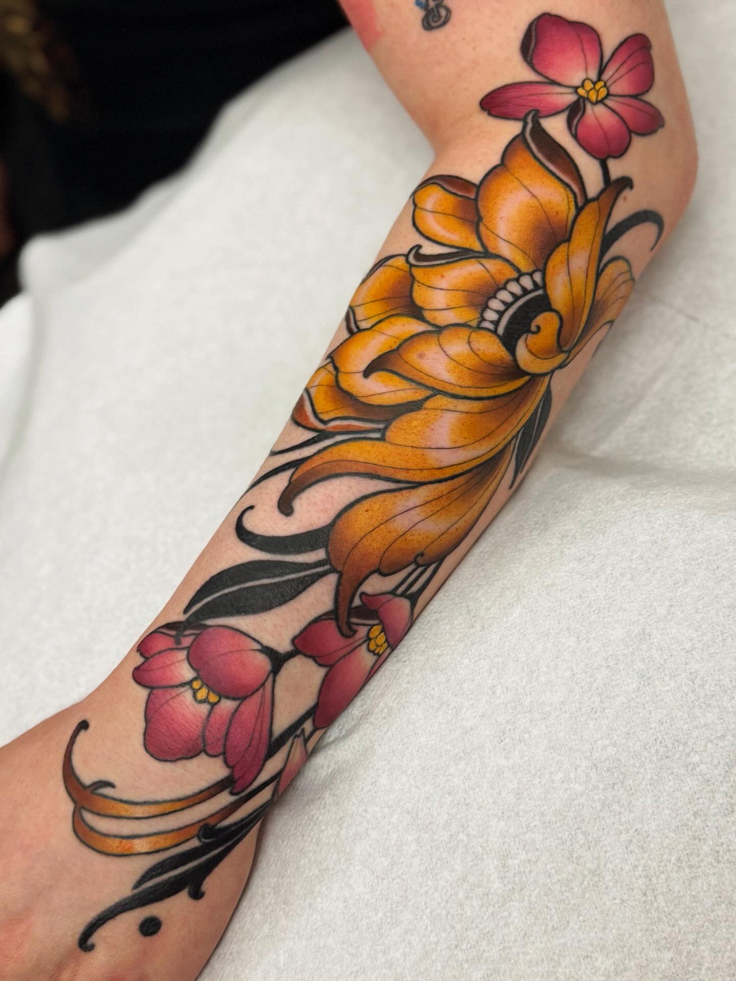 Neo-traditional floral sleeve tattoo for men with bold outlines and saturated colour