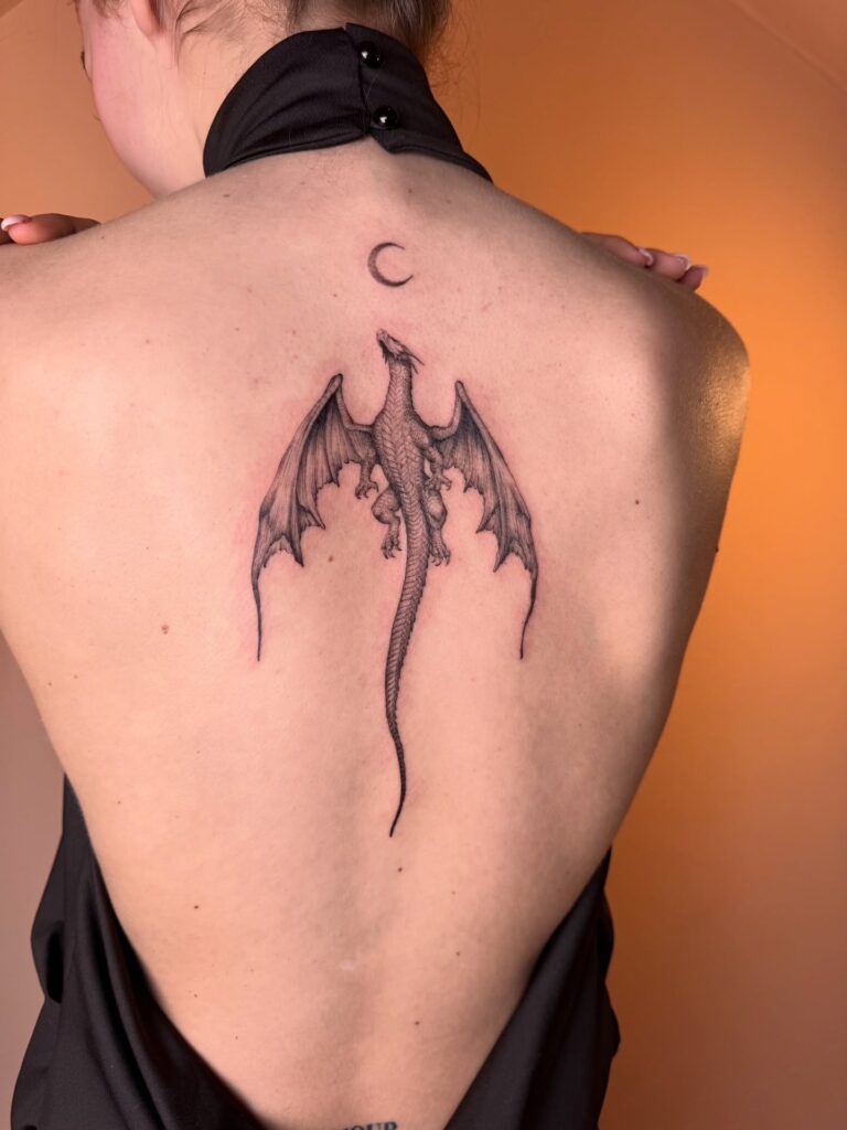 Dragon tattoo for women running down the spine from the nape to the lower back