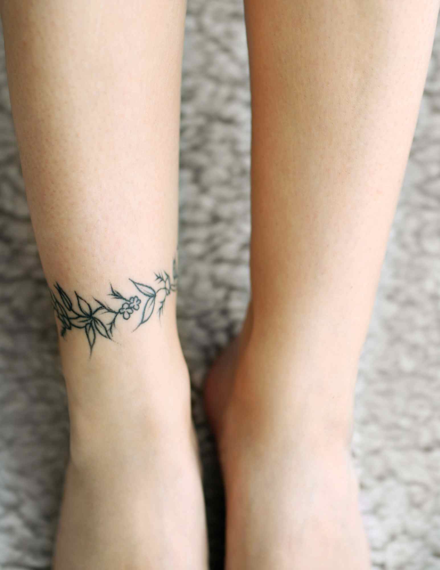 Fine line vine tattoo wrapping around an ankle, a placement worth testing in a tattoo design app before booking