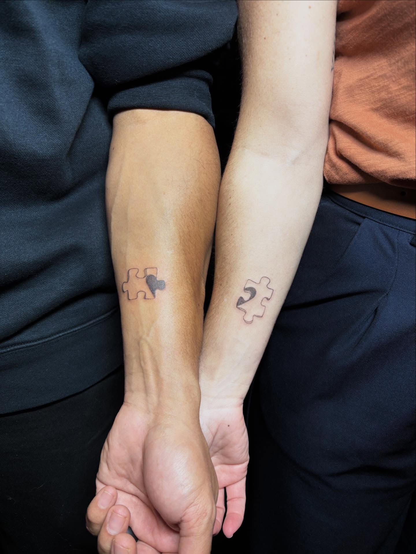 Matching puzzle piece tattoos for best friends that interlock when hands are held side by side.