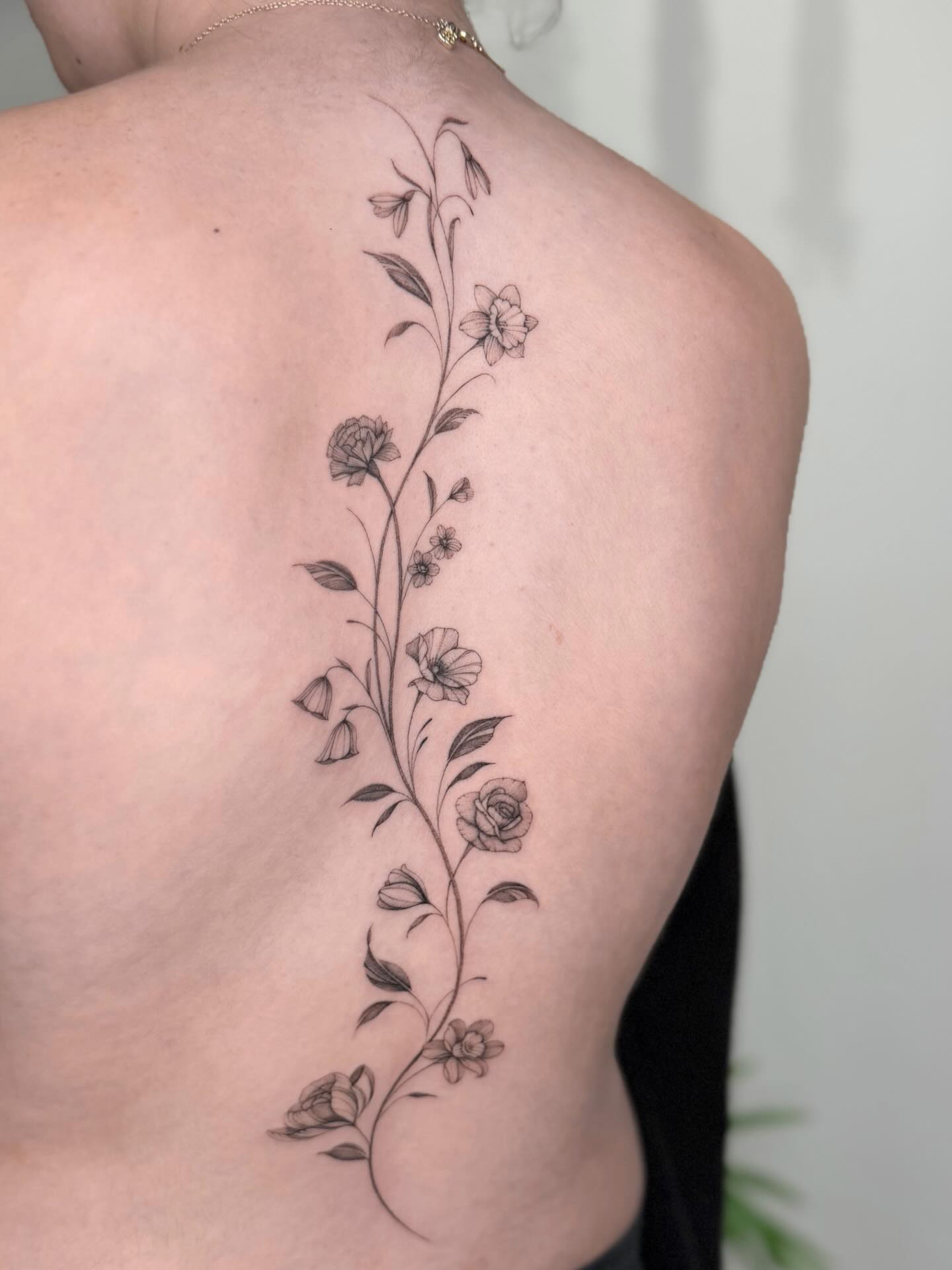 Ornamental mandala spine tattoo with stacked geometric medallions along the spine