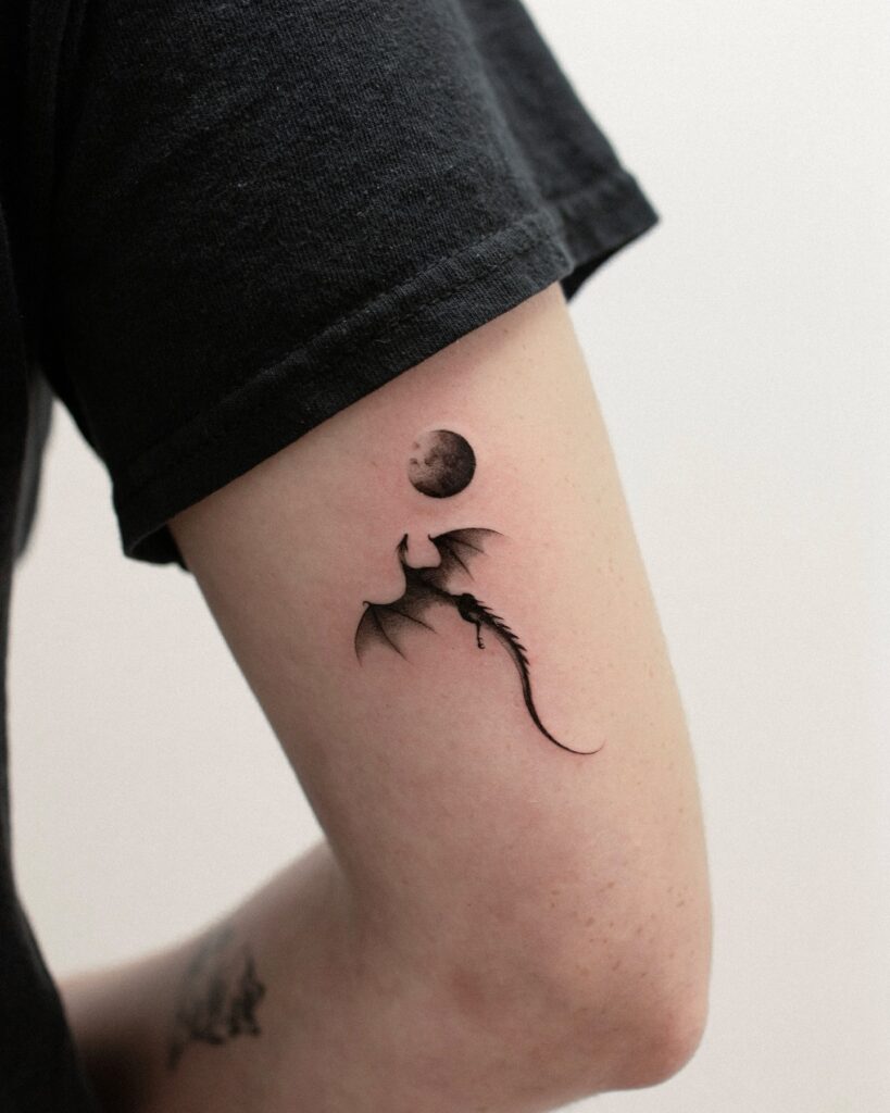 Dragon tattoo for women wrapping the forearm in a compact black and grey design