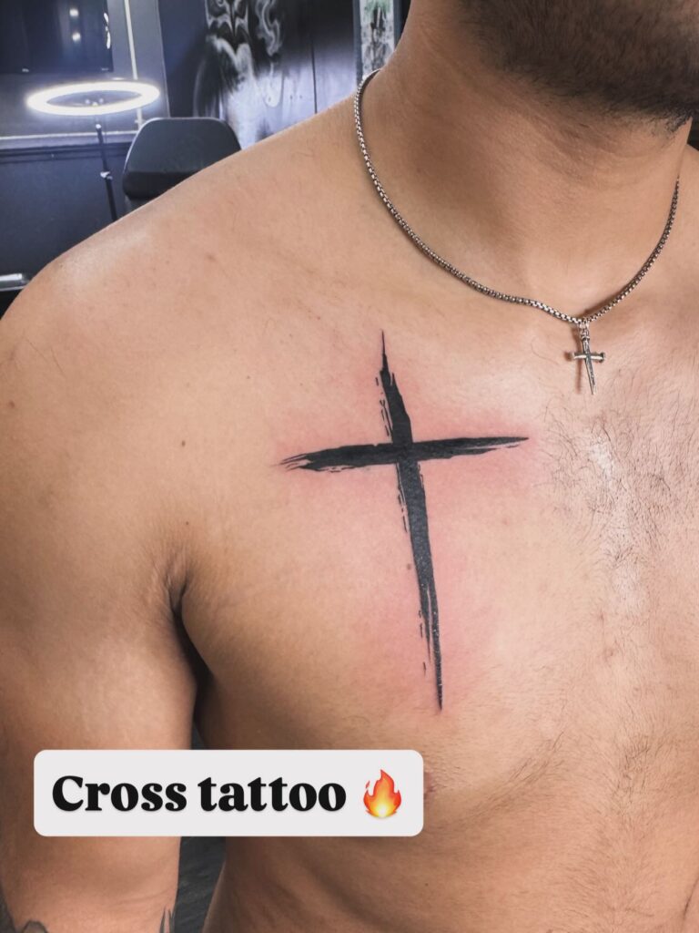 Simple cross tattoo for men, a small meaningful tattoo representing faith and ancestry