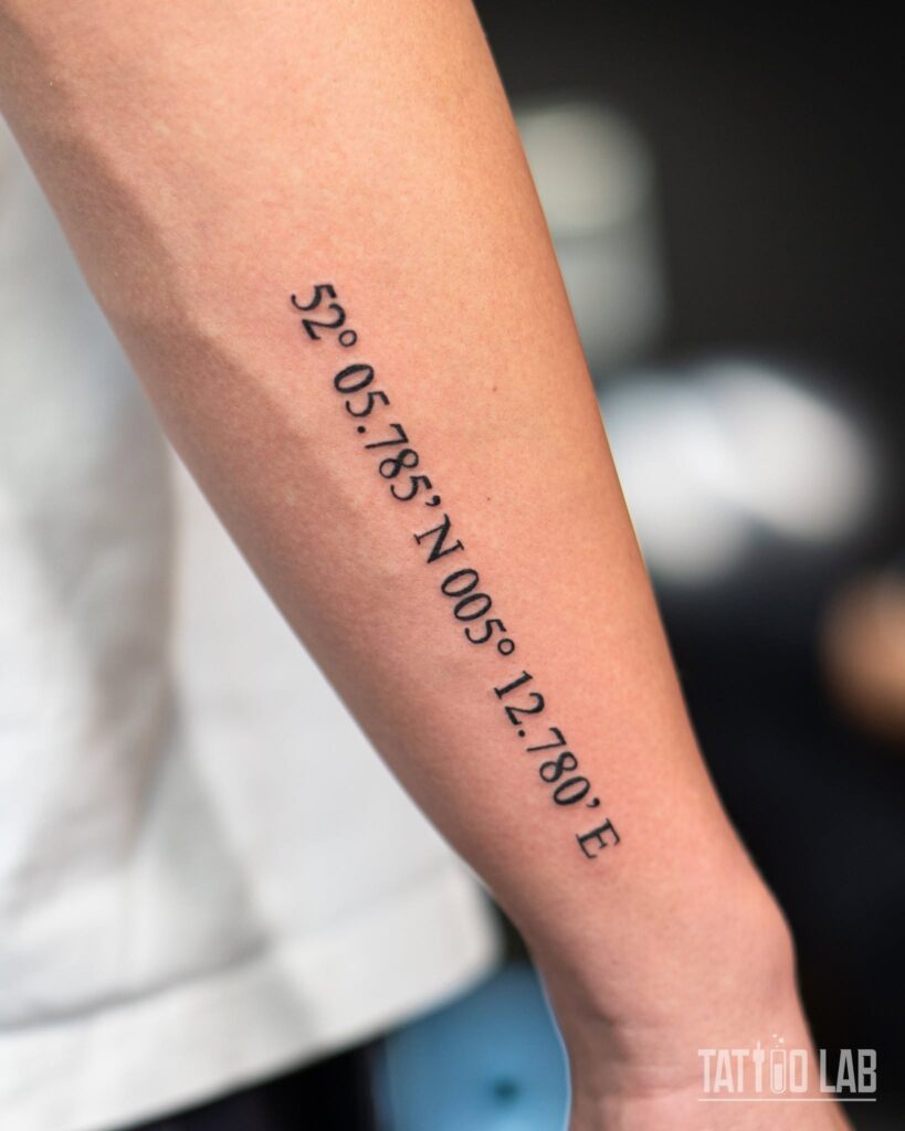 Coordinate tattoo marking the place two people met, lettered in small delicate type