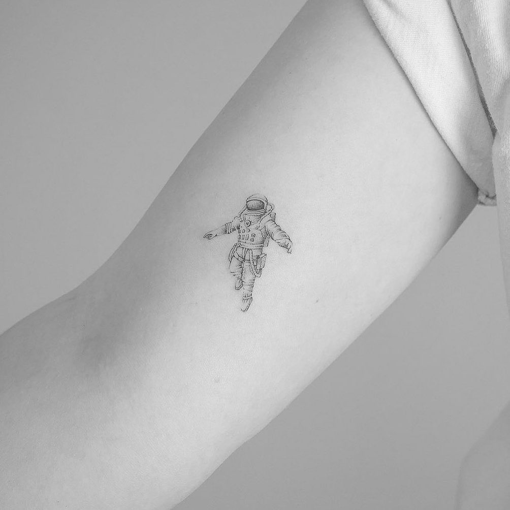 Small fine line tattoo on the inner arm, illustrating a realistic small tattoo cost range