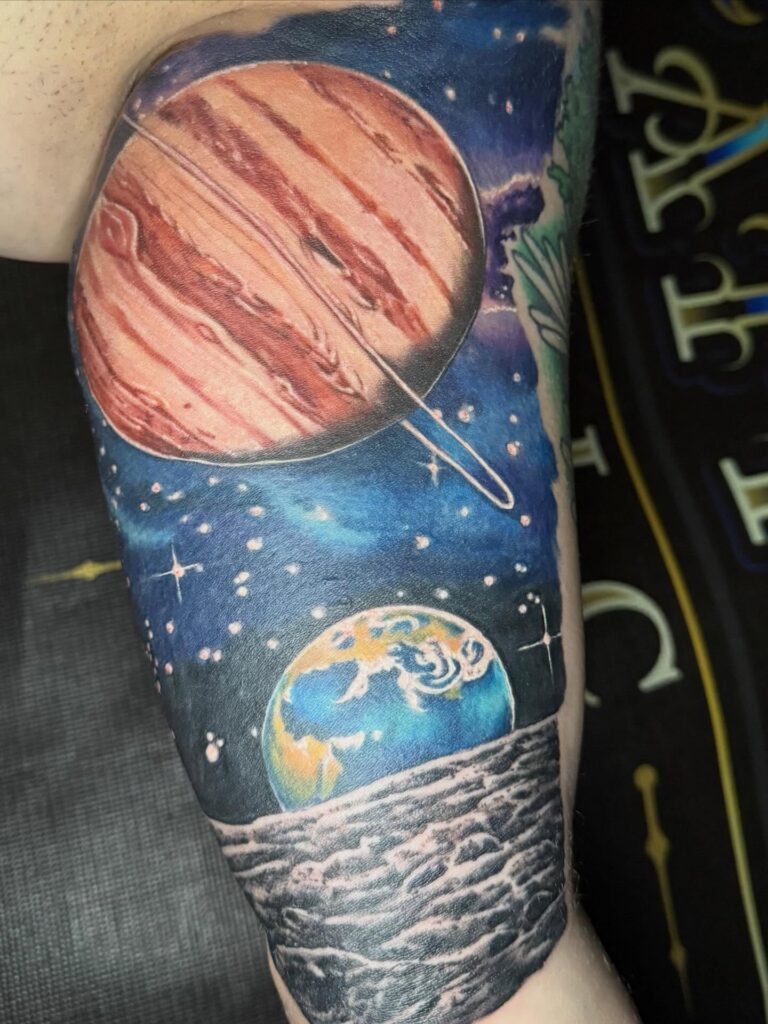 Earth from space tattoo rendering the blue marble planet in fine detail