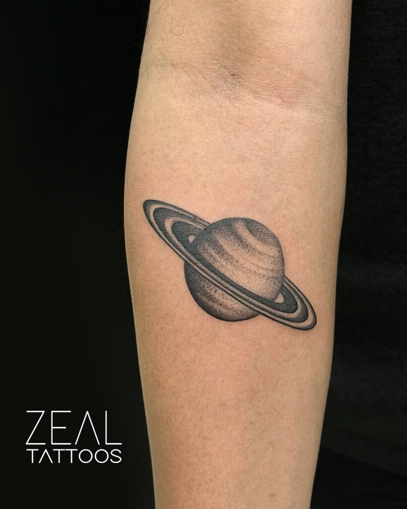 Saturn space tattoo with detailed rings and banded atmosphere shading