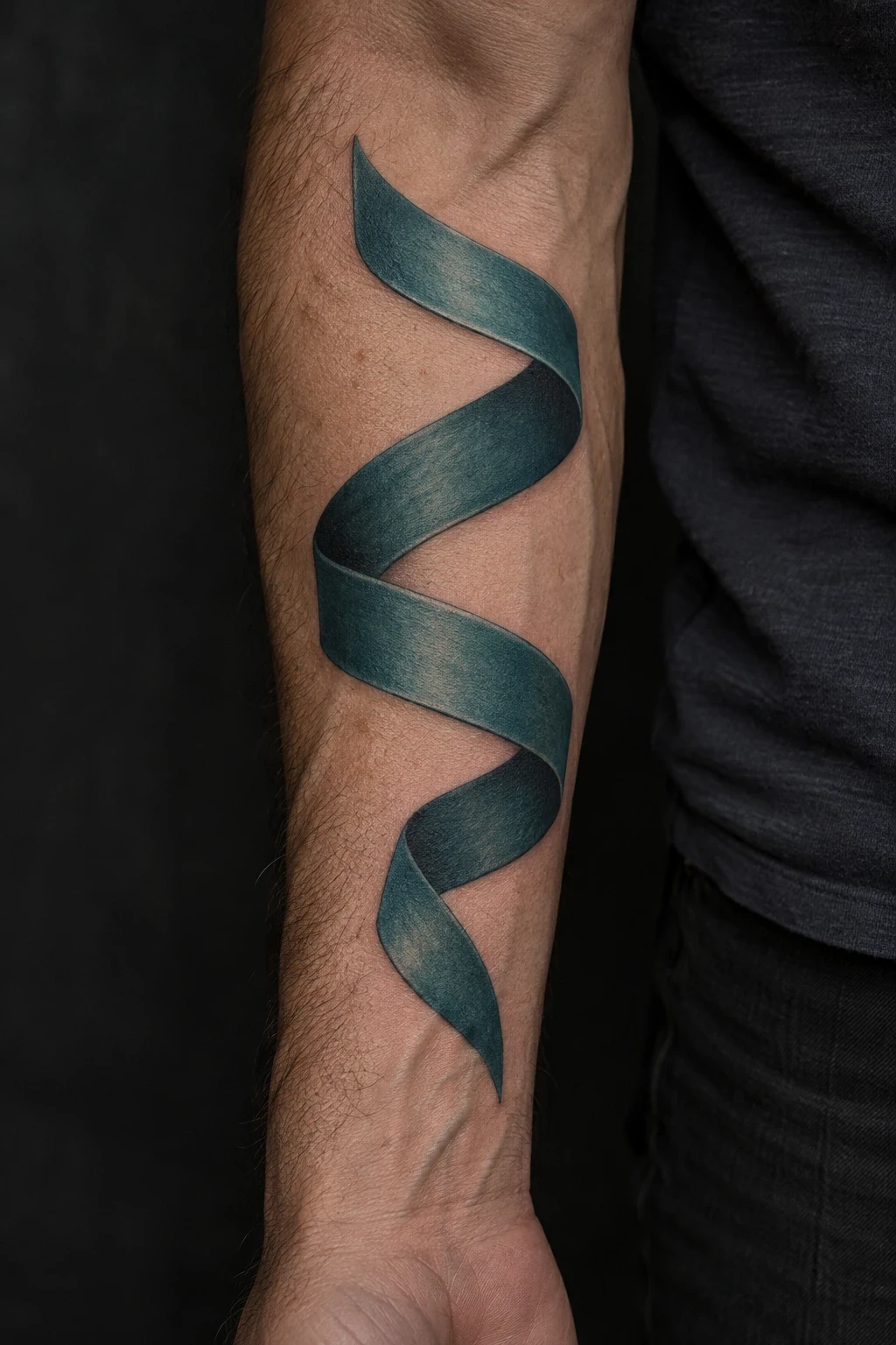 Teal ribbon tattoo with a shaded S-shaped twist on a forearm