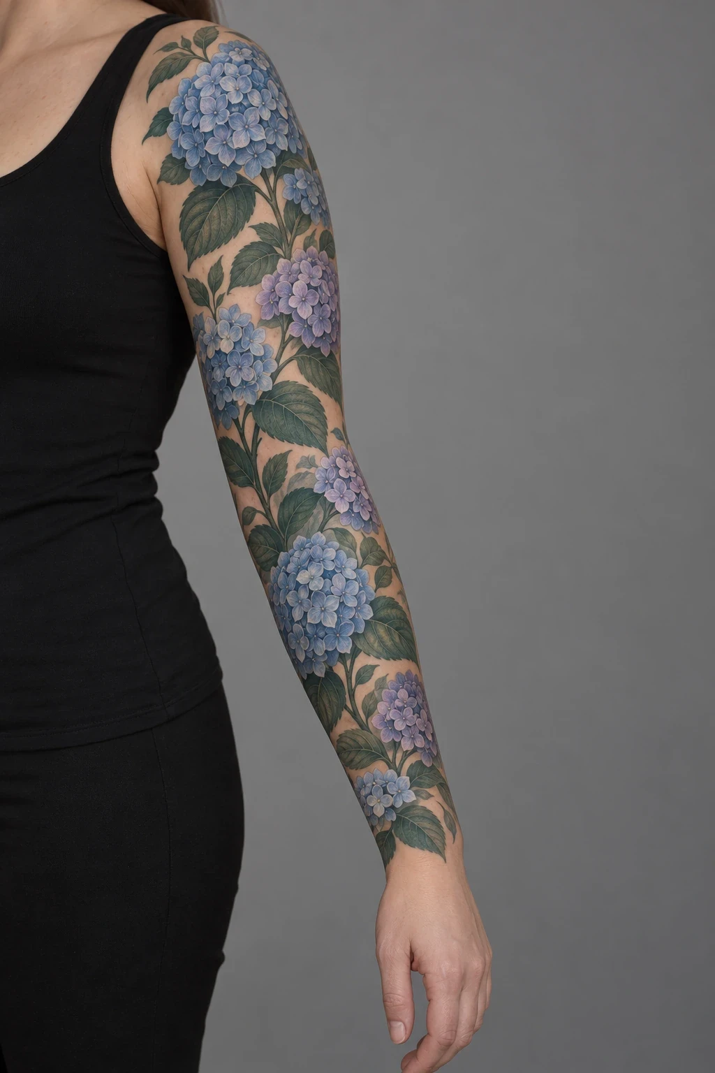 Blue and lavender hydrangea clusters with broad leaves in a full sleeve
