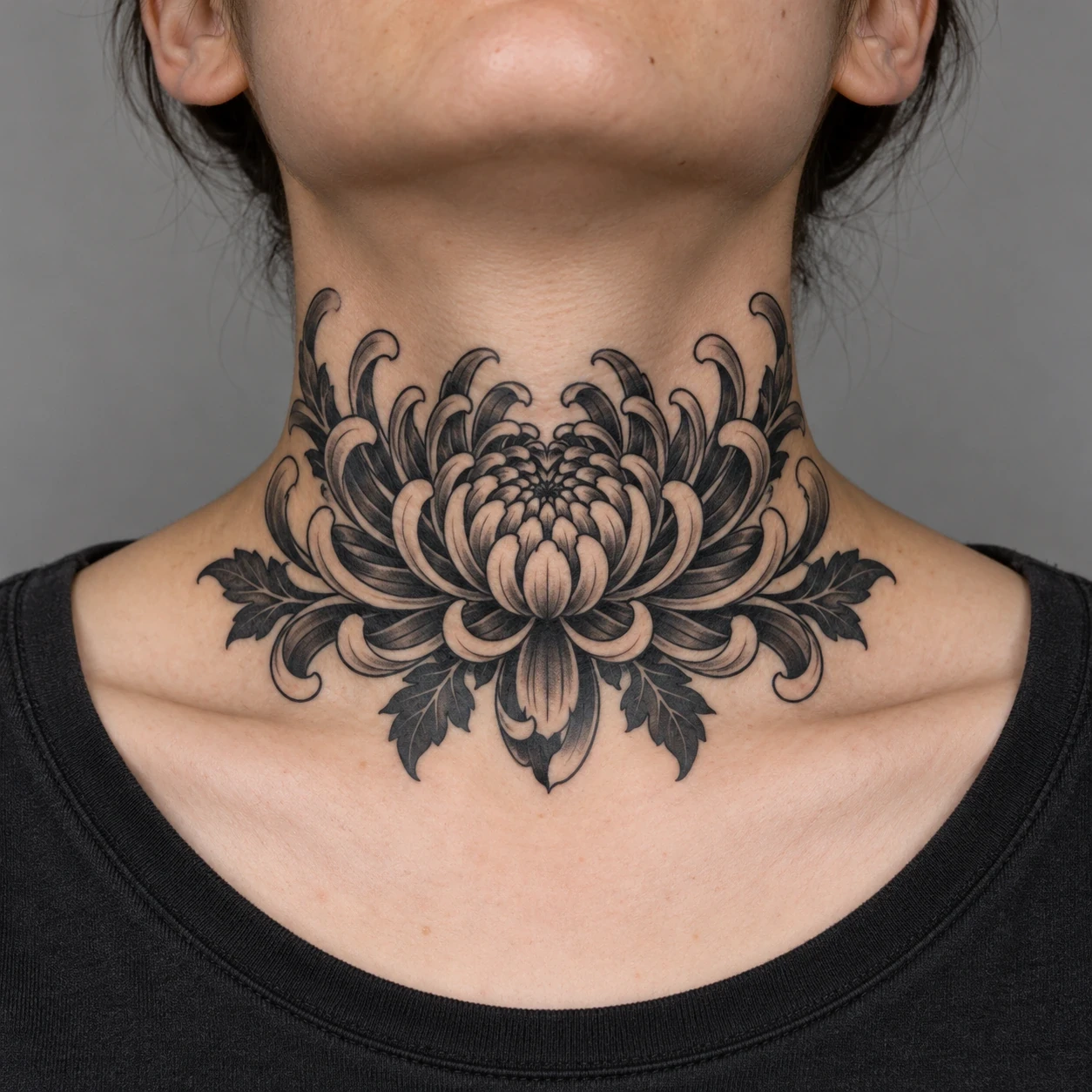Black and grey chrysanthemum centered at the front base of a neck