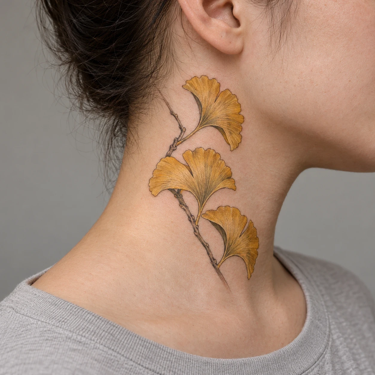 Golden ginkgo leaves on a small branch at the side of a neck